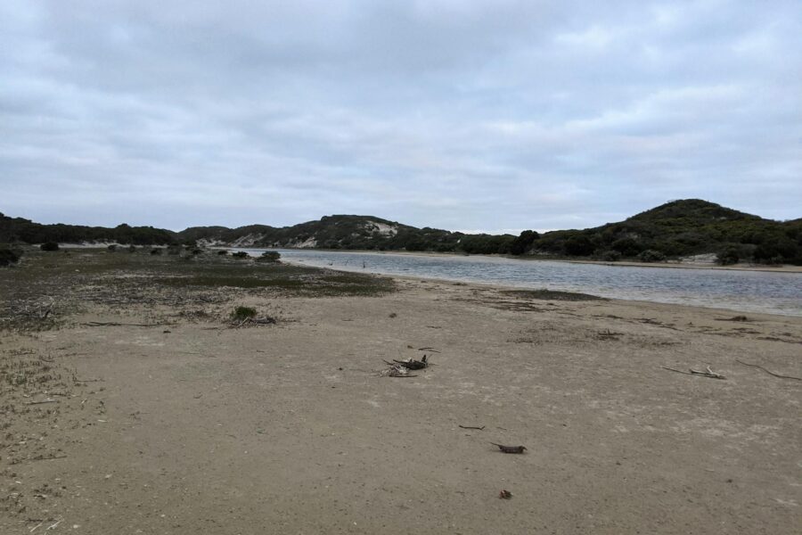 Beach down to a river.
