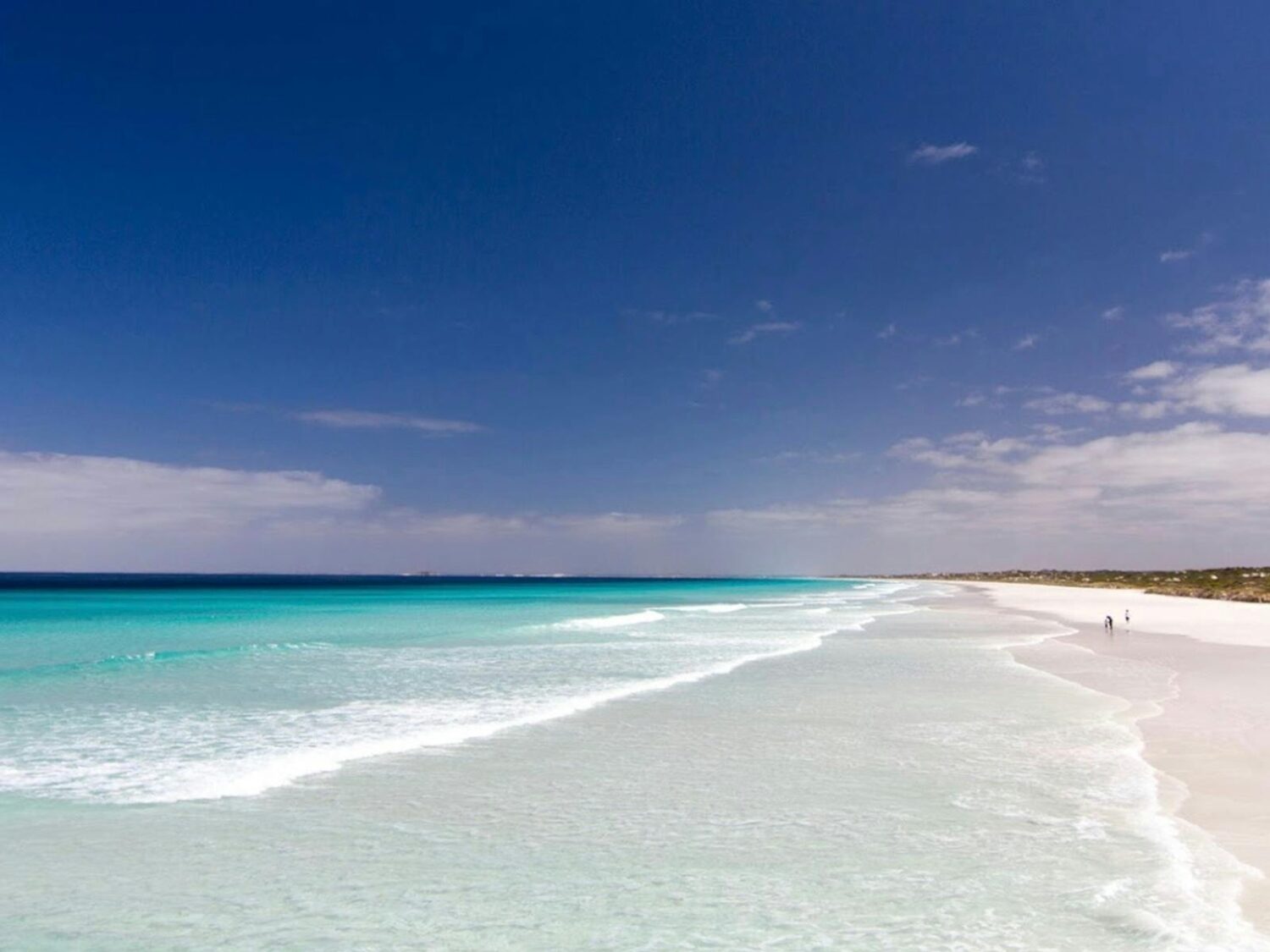 Blue water, blue skies and white sandy beach.