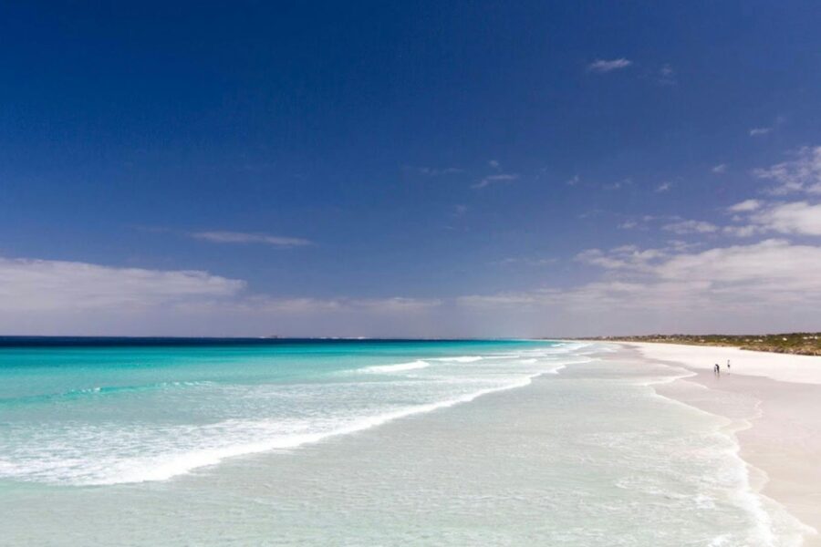 Blue water, blue skies and white sandy beach.