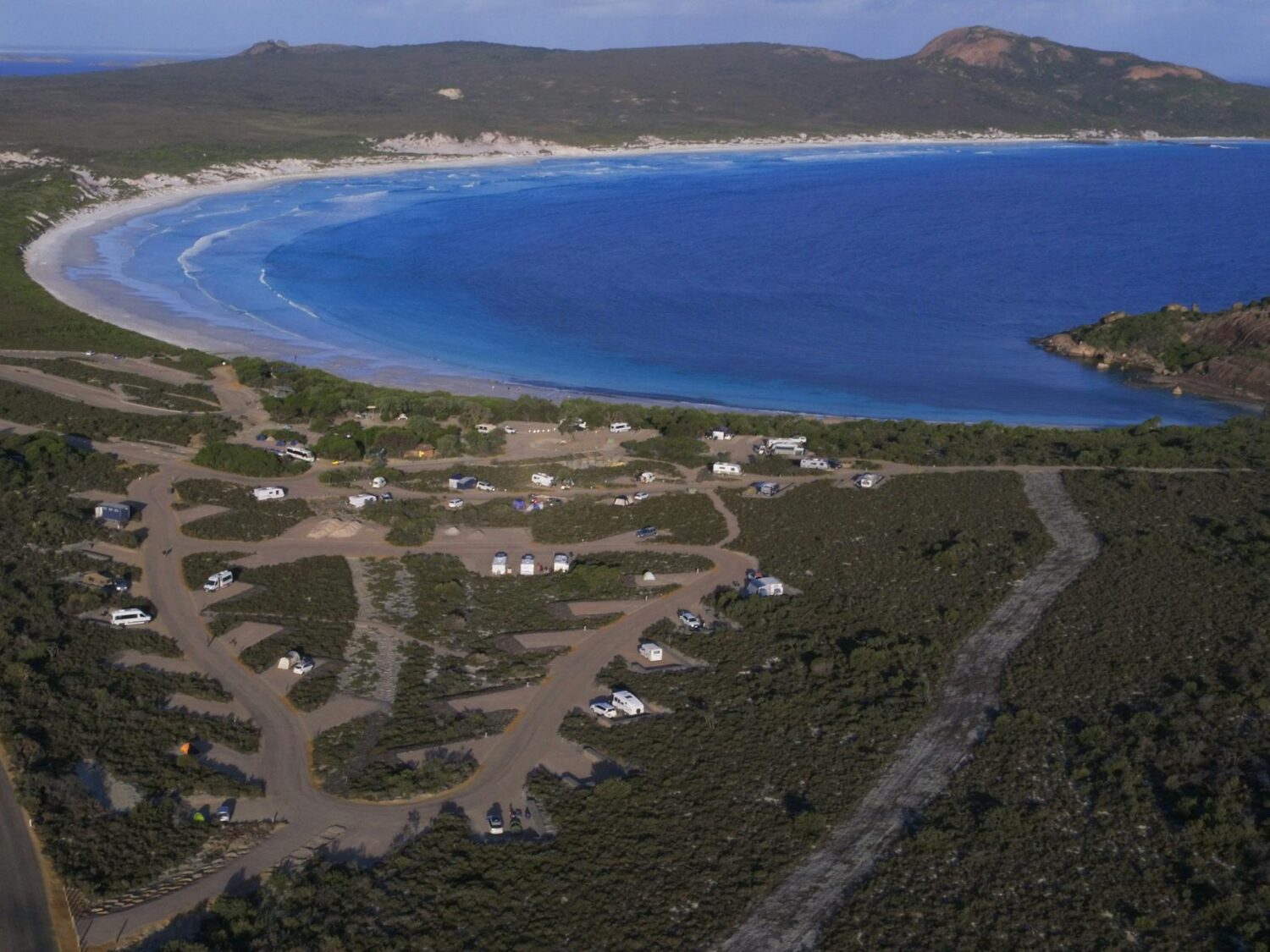 Aerial view of campgrounds near a large bay.