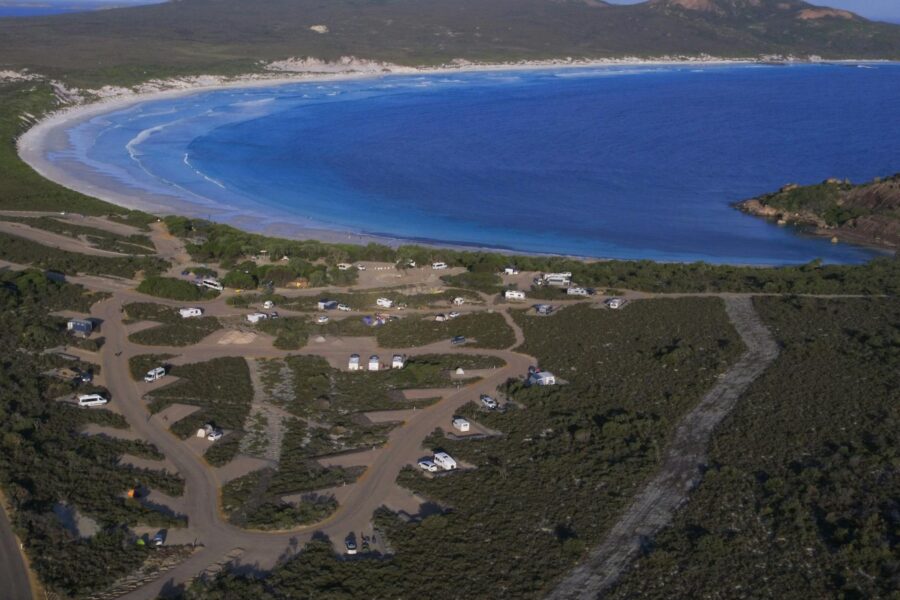 Aerial view of campgrounds near a large bay.