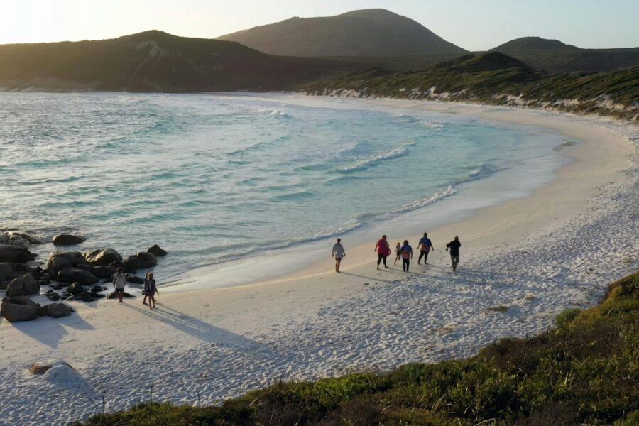 Guests walking along the white sandy beaches of Mandawoornup