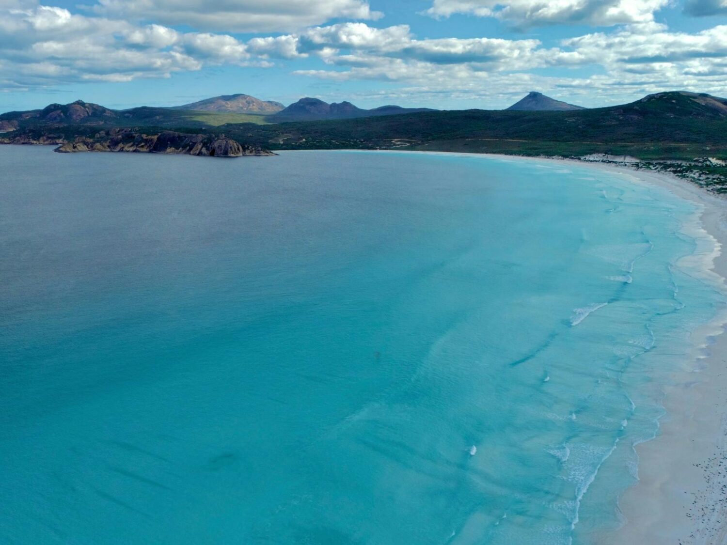 Drone photo over ocean to Lucky Bay Beach and beyond