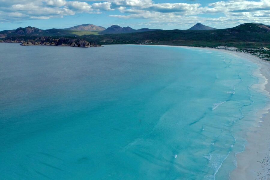 Drone photo over ocean to Lucky Bay Beach and beyond