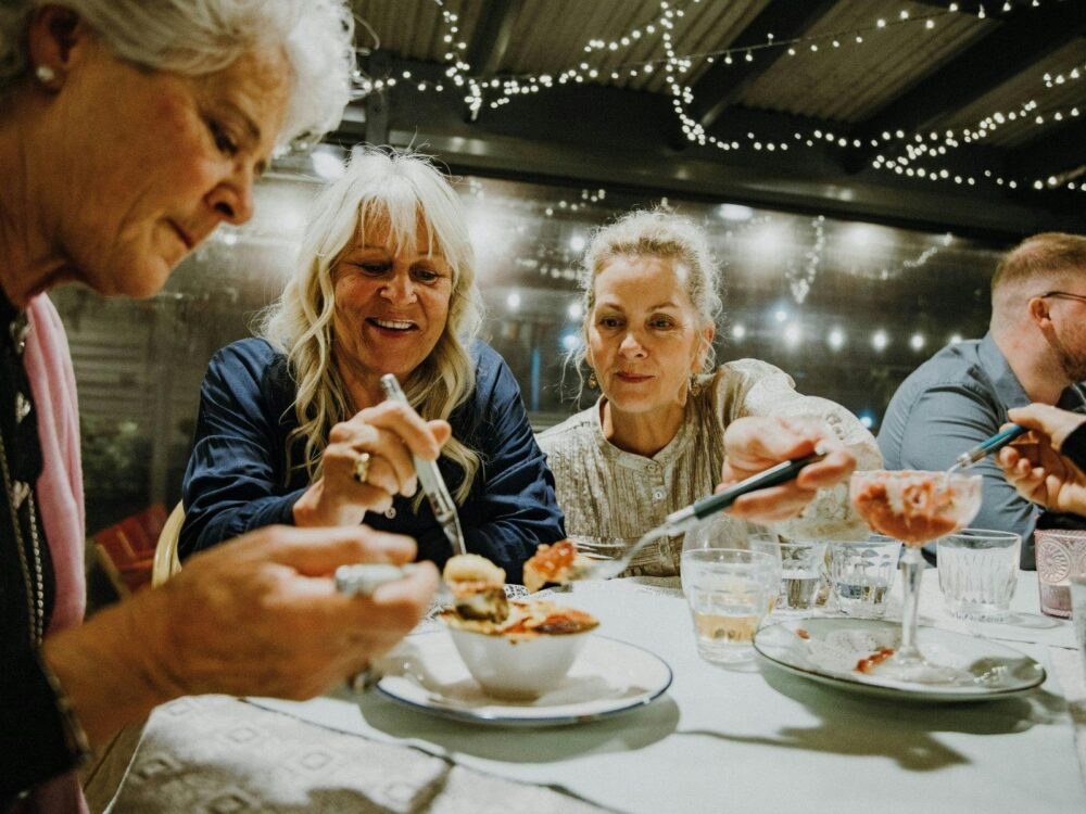 Three guests share a creme brulee
